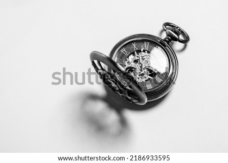 Black and white photo of an antique pocket watch.