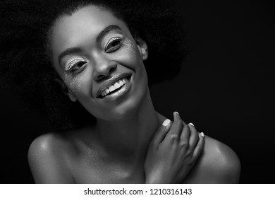 black and white photo of attractive pensive african american woman looking away isolated on black
