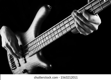 Black And White Photo Of Bassist Playing Electric Bass Guitar