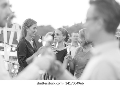 Black And White Photo Of Business Colleagues Enjoying Success Party On Rooftop During Sunset