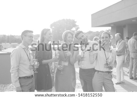 Similar – Multiethnic friends resting outside food truck in evening