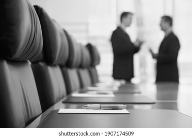 Black And White Photo Of Businessmen Talking In Conference Room