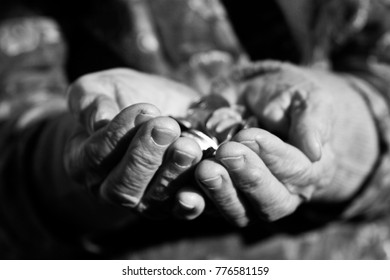 - Black And White Photo Of Coins In Old Wrinkled Hands Close-up