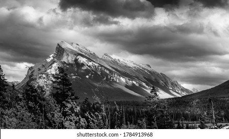 Black and White Photo of Dark clouds hanging over Mount Rundle in Banff National Park in the Canadian Rocky Mountains 