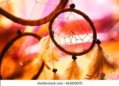 black and white photo of a dream catcher at sunset purple dark background.