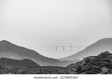 Black and White photo of the epic Hong Kong-Zhuhai-Macao Bridge, viewing from mountain side, Lantau Island