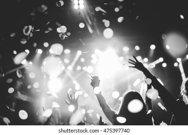 Black and white photo of a festival crowd rising their hands.