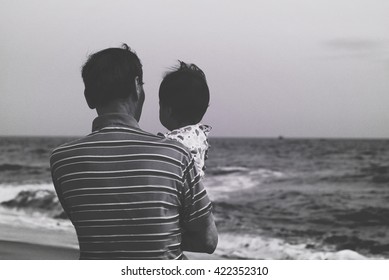 Black And White Photo Of Grandfather Holding His Grandchild At The Beach, Silhouette