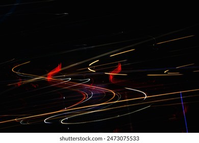 A black and white photo of a highway with red and yellow streaks. The streaks are the reflections of lights from cars and trucks. The photo has a moody and mysterious feel  - Powered by Shutterstock