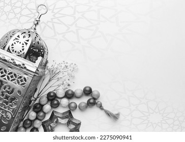 A black and white photo of a lamp and beads with copy space islamic ramadan greeting background . Ramadan Kareem. Islamic greeting template with ramadan for wallpaper design