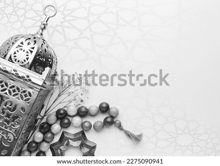 A black and white photo of a lamp and beads with copy space islamic ramadan greeting background . Ramadan Kareem. Islamic greeting template with ramadan for wallpaper design