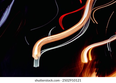 A black and white photo of a long, curvy line with a red stripe. The photo has a mood of motion and energy, as if it were a wave or a streak of light