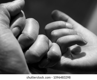 Black and White photo of Mom and Son making a pinkie promise together, Selctive focus of Parent and Child holding  fingers together, Promising and Protecting concept