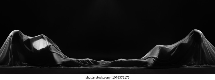 Black and White photo in Nude Artistic sexy beautiful figure girl under hiding in light thin fabric, to show silhouette of woman body lying on floor, female in shadow, copy space area for text logo