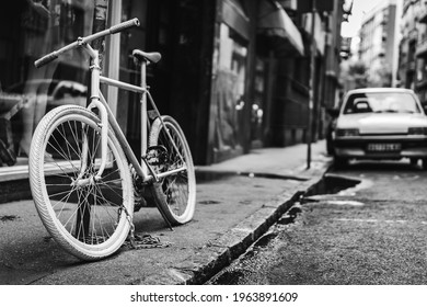 Black And White Photo Of An Old Bycicle In The Street