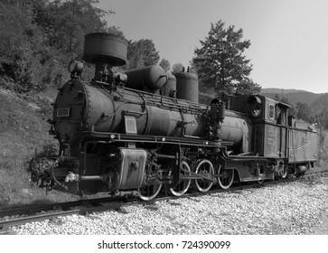 Black & White photo of a old locomotive with wagons