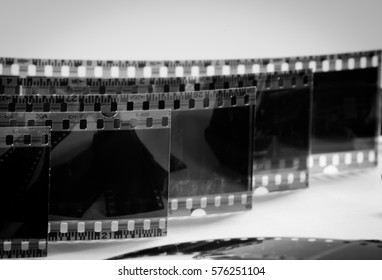 black and white photo of old negatives on a white background