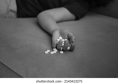 black and white photo. Overdose pills and addict concept background. woman sleep unconscious after eaten pills on bed,Commit suicide, Drug overdose concept