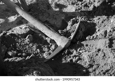 A Black And White Photo Of A Pick Ax.