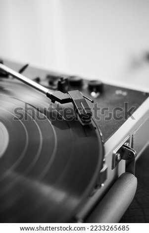 Black and white photo of a record player. Close up photo. Vertical photo.