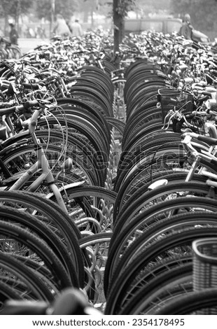 Black and white photo of a row of  bicycles parked in city of Amsterdam, The Netherlands