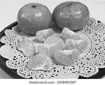 black and white photo of a series of neatly arranged fruits, grapes, oranges, pineapples, pears, apples, strawberries in black and white shades - Powered by Shutterstock