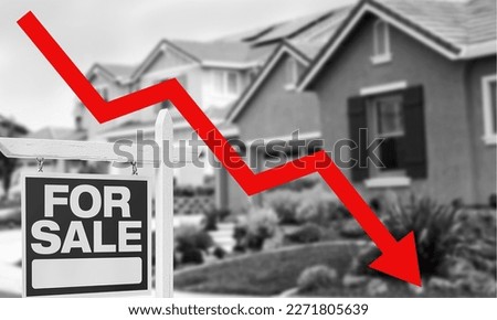 Black and white photo showing house for sale with a descending arrow indicating a price drop