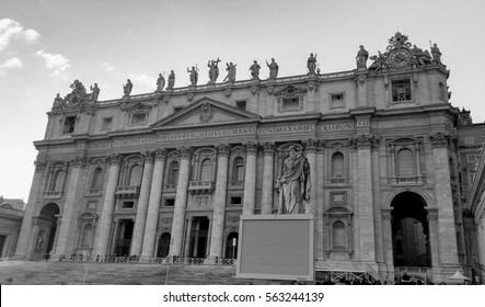 Black and white photo of St. Peter Basilica front entrance with statues, Vatican Rome