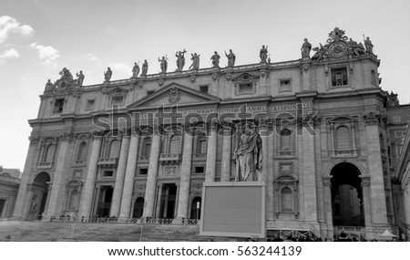 Black and white photo of St. Peter Basilica front entrance with statues, Vatican Rome