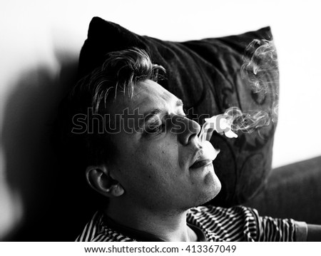 Similar – young guy in a shirt smokes on the street