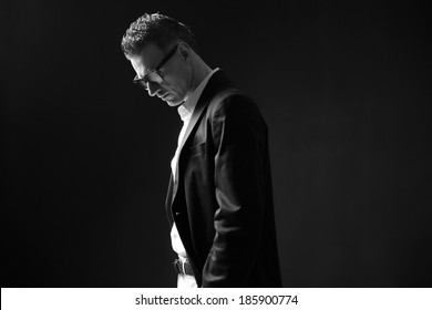 Black and white photo of a thoughtful businessman in glasses