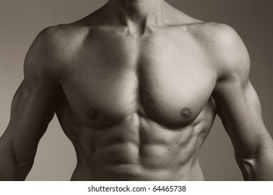A black and white photo of the torso of a muscular man.