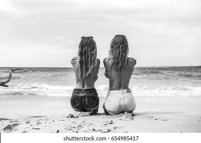 Black and white photo of two girls on the beach at Jervis Bay, Australia