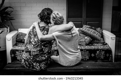 Black and white photo of two women friends hugging each other.  - Shutterstock ID 1963213345