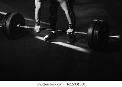 Black And White Photo Unrecognizable Athletic Man Having Weight Training With Barbell In Health Club. Copy Space.