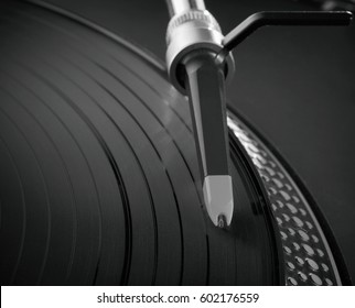 Black And White Photo Of Vintage Dj Turntables Needle Cartridge In Focus.Overhead Shot Of Dj Turntable Tone Arm.Professional Vintage Dj Audio Equipment Macro.Retro Hipster Vinyl Records Player Closeup