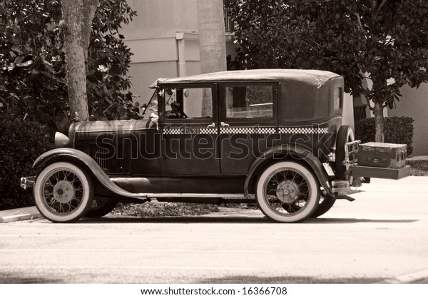 Black and white photo\
of vintage taxi cab