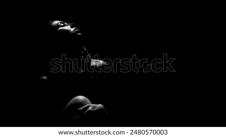 Similar – Young woman in black lingerie in chiaroscuro lighting