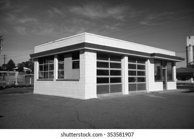 Black And White Photo Of Worn Vintage Abandoned Auto Repair Garage                           