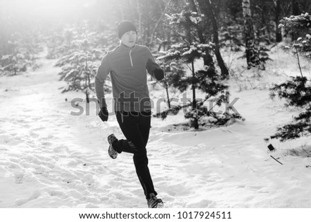 Similar – Young man running outdoors during workout in a forest