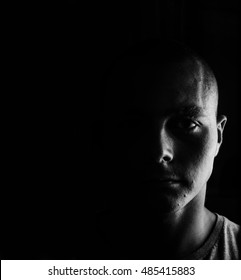 Black And White Photo Of The Young Man Close Up Portrait, On Black Background
