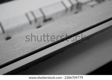 Black and white photograph of a window ledge and border. 