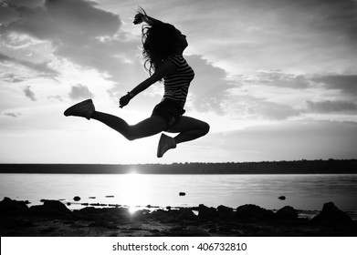 Black And White Photography Of Dance And Jump, Silhouette Outdoors Background. Dawn Sky