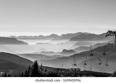 black and white photography with a light mist that stratifies the mountains of the Asiago plateau in the province of Vicenza Italy with a chairlift - Powered by Shutterstock