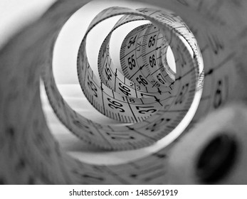 Black And White Photography Which Depicts A  Spiral Created With A Meterstick