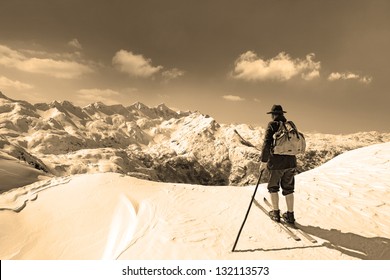 Black and white photos, Old skier with traditional old wooden skis and backpack
