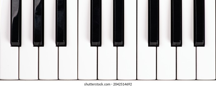black and white piano keys, music synthesizer keys top view.