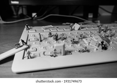 Black And White Picture About Little Worker Men Cleaning A Keyboard, IT Workers, Keyboard Disassembly, Keyboard Cleaning, Keyboard Repair 