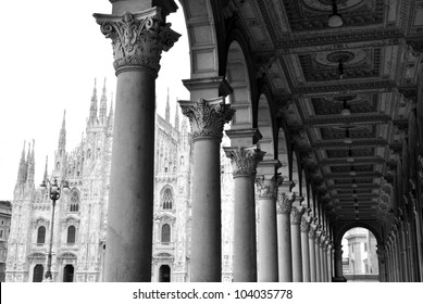 Black and white picture of ancient arcade and gothic cathedral of Milan, Lombardy, Italy