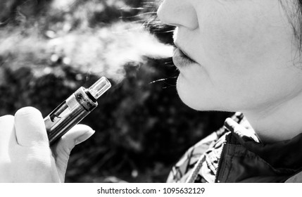 Black And White Picture Close-up Of A Middle Age Woman Smoking An Electronic Cigarette, Not Healthy Concept.